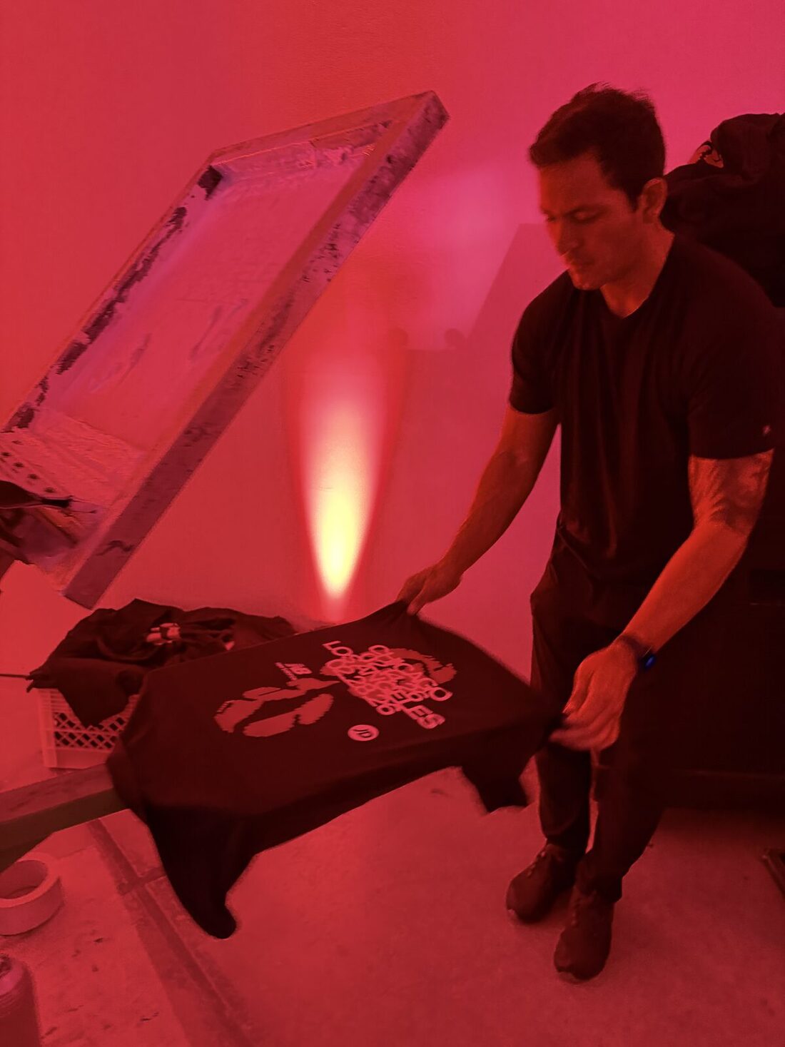 Guests watching a printer pull a squeegee at a Austin event
